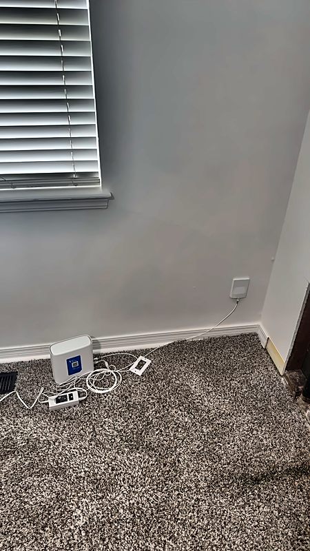 A customer's router and cabling photographed in place before work on a 4D Restoration job.